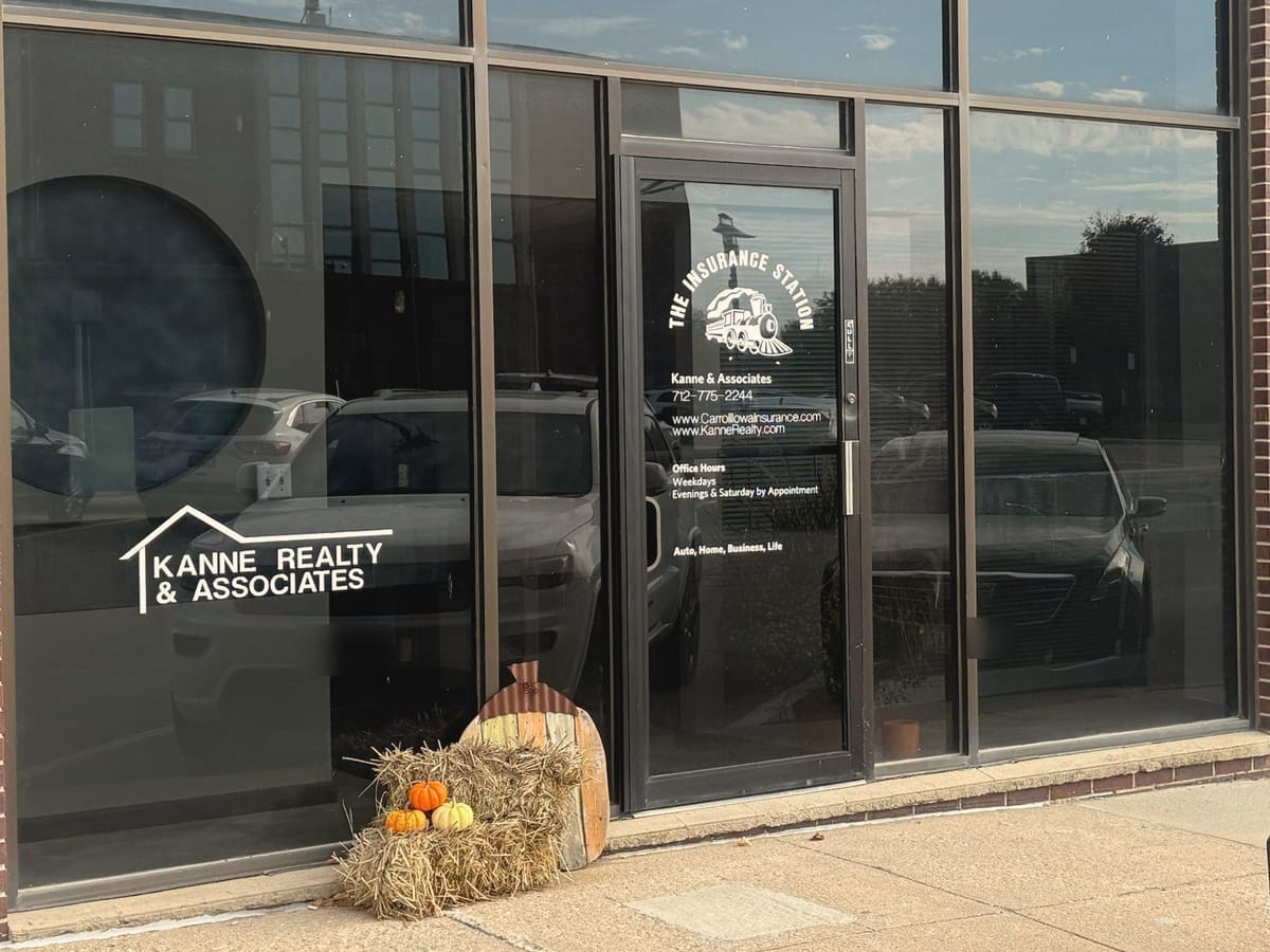 The Kanne Realty & Associates storefront, with The Insurance Station logo on the glass door.